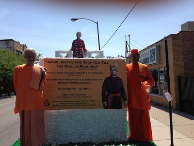 Swami Varadananda and Swami Ishatmananda with the float ID Parade Float with Swamis